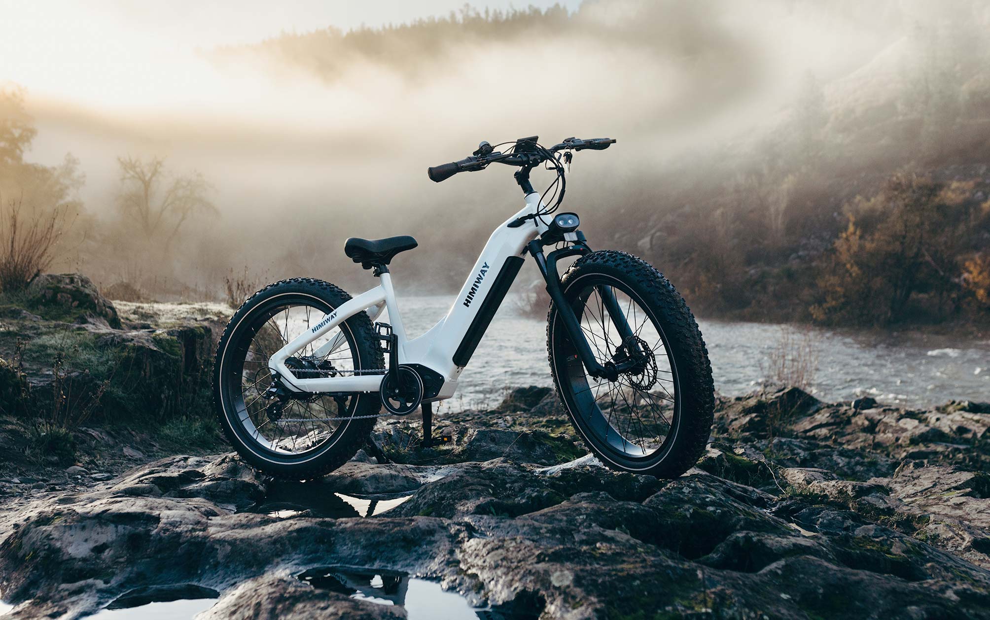 Electric Bike Standing on Rocks Crossing River Electric Bike Standing on Rocks Crossing River